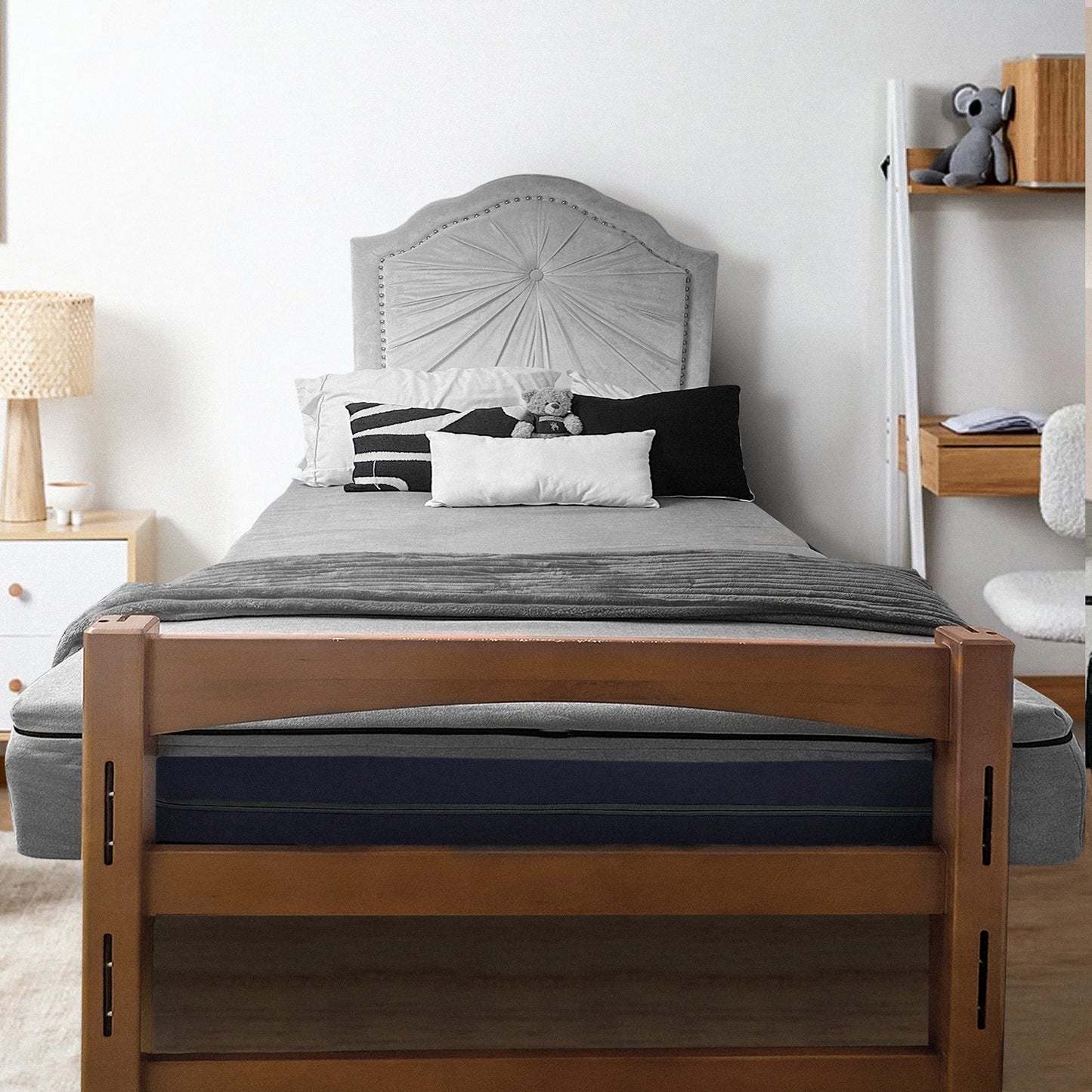 Cozy bedroom with wooden bed frame and gray bedding, featuring twin XL mattress topper for college comfort
